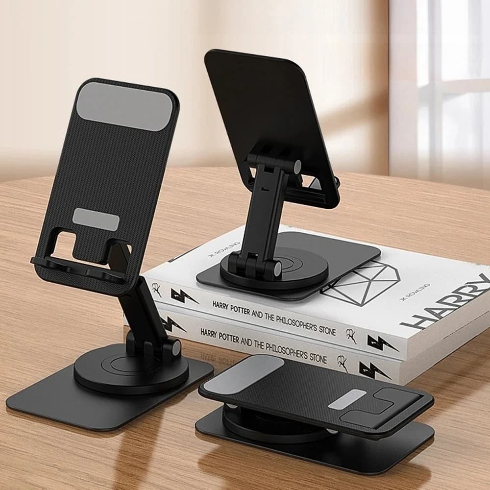 İki siyah yuvarlak tabanlı telefon standı, kitap üzerinde açılı