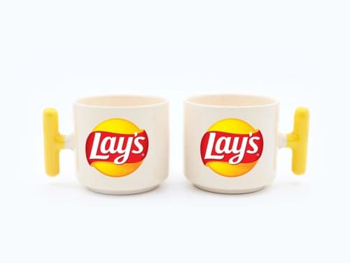 İki adet sarı kulplu krem promosyon latte fincanı, kırmızı sarı logo baskılı